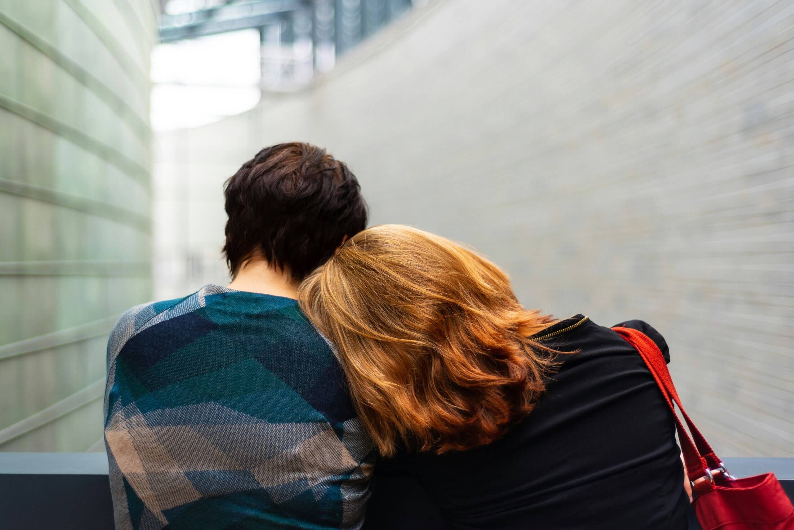 Woman leaning head on another woman's shoulder
