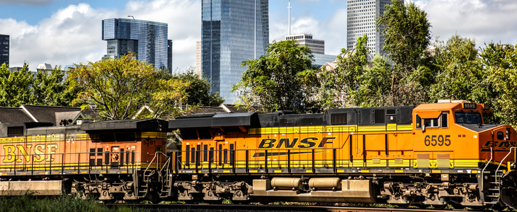 a locomotive train, with the Houston skyline in the background