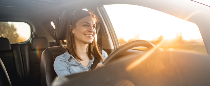 woman smiling while driving straight