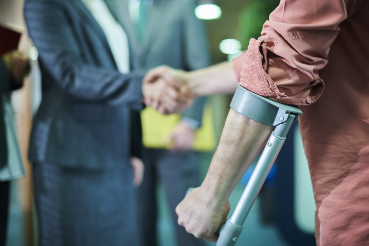 Injured man shaking hands with personal injury attorney