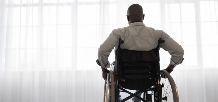 Man in a wheelchair due to a spinal cord injury