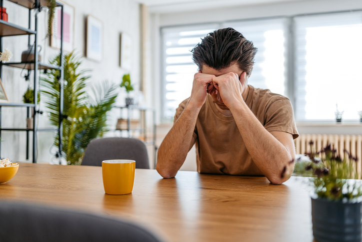 Stressed man sitting at a table